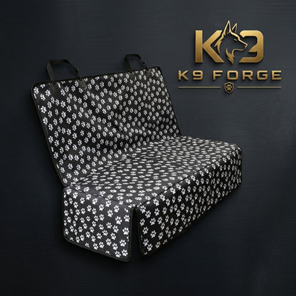 K9 Forge black dog car back seat cover with white paw print pattern – waterproof quilted pet seat protector for SUV truck family car – cute dog travel accessory