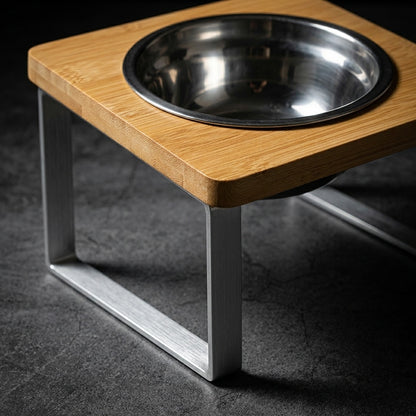 Wooden pet feeder with a metal bowl on a dark surface