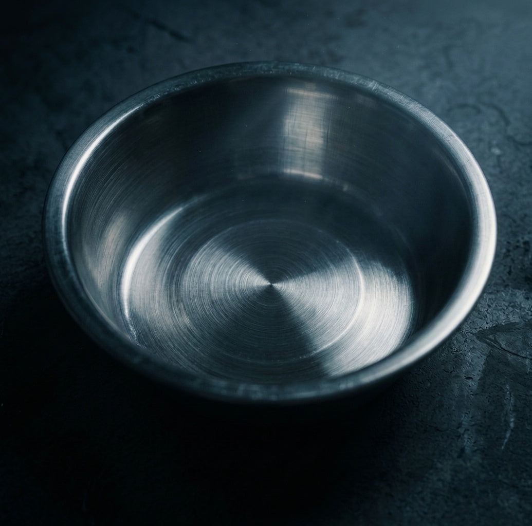 Metallic bowl on a dark textured surface
